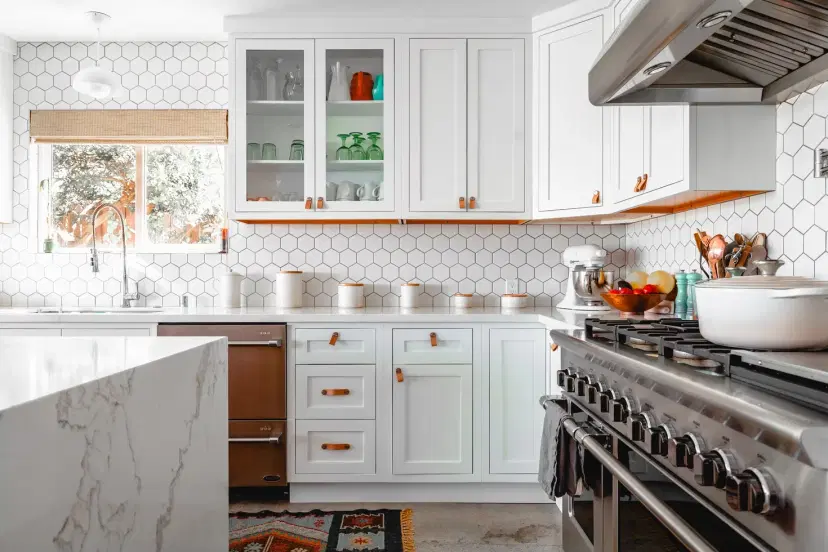 Modern white kitchen with stainless steel range