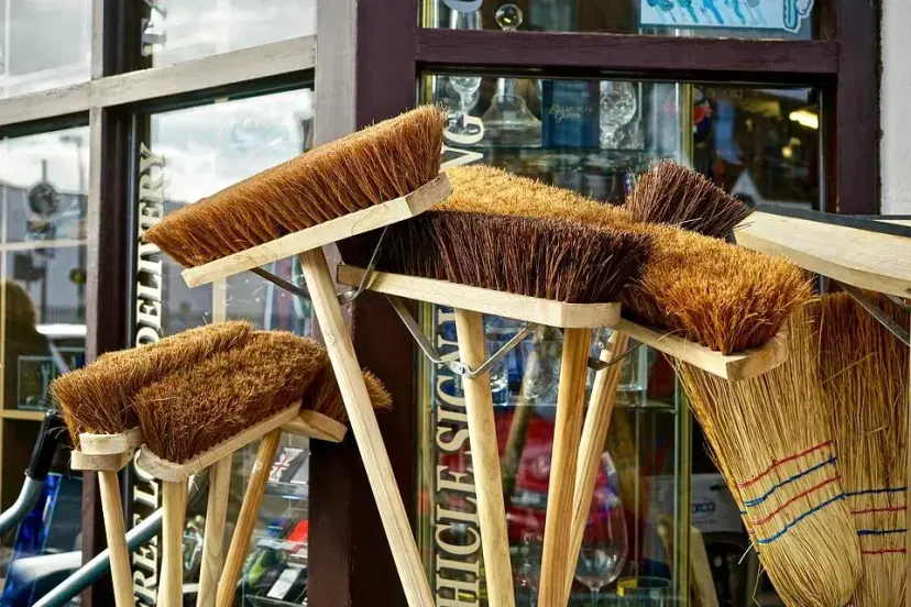 Collection of natural bristle brooms displayed