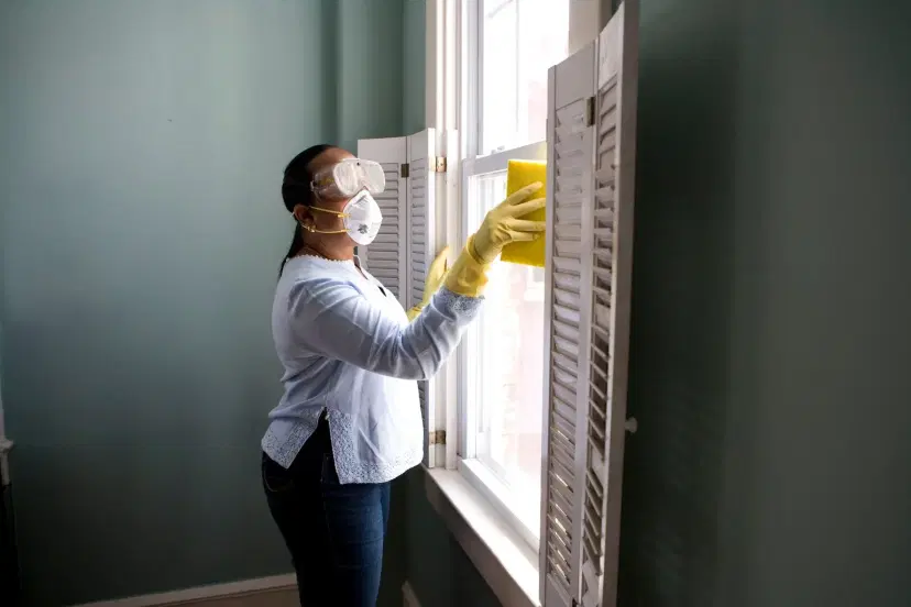 Woman Cleaning Window with Protective Gear