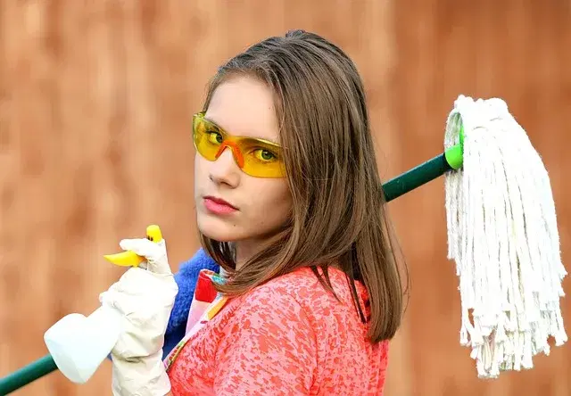 Professional house cleaner wiping down blinds in an Ottawa home