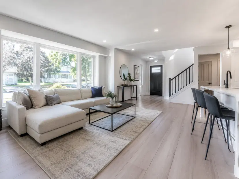 A bright, freshly cleaned Ottawa living room after renovation, natural light, visible clean floors and windows