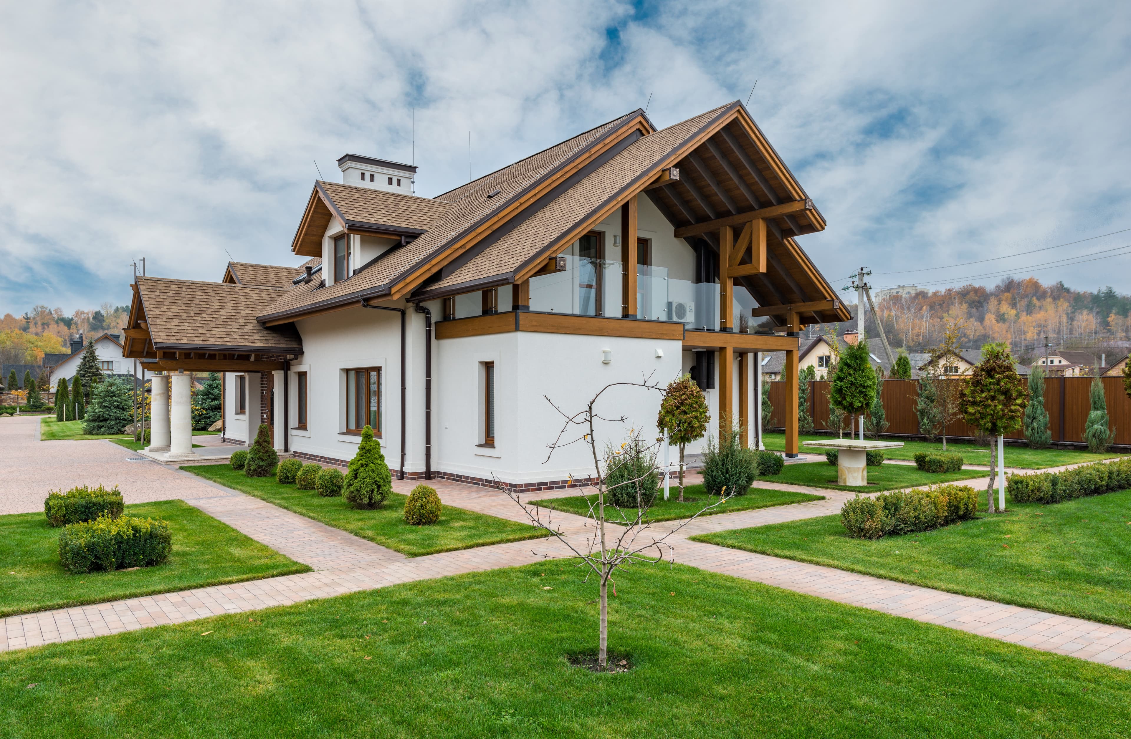 house with a green lawn and white/brown exterior