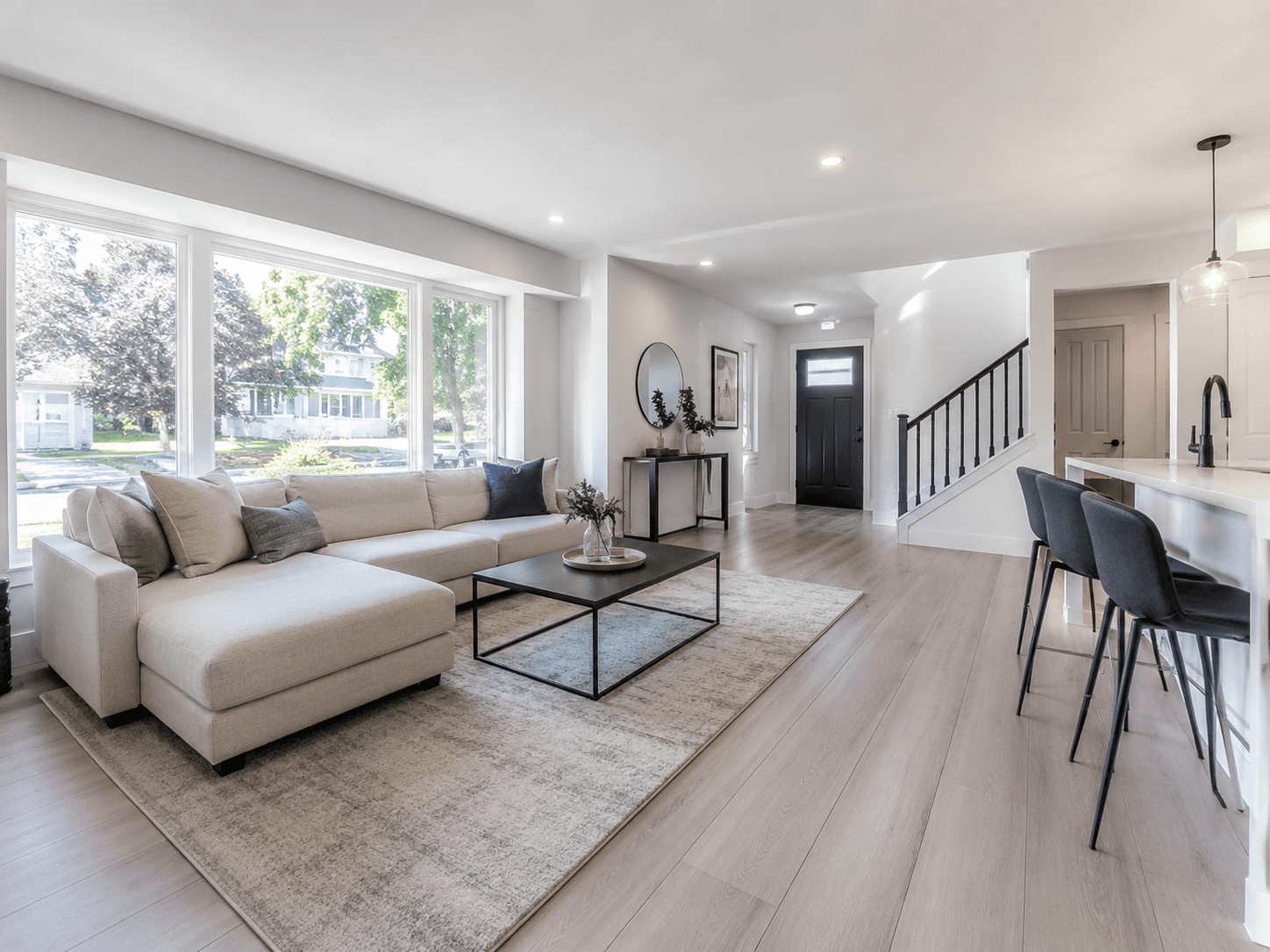 A bright, freshly cleaned Ottawa living room after renovation, natural light, visible clean floors and windows