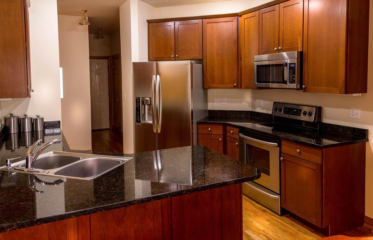 Modern kitchen with stainless steel refrigerator, range, and microwave appliances