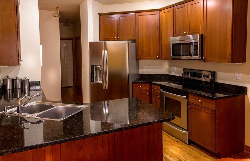 Modern kitchen with stainless steel refrigerator, range, and microwave