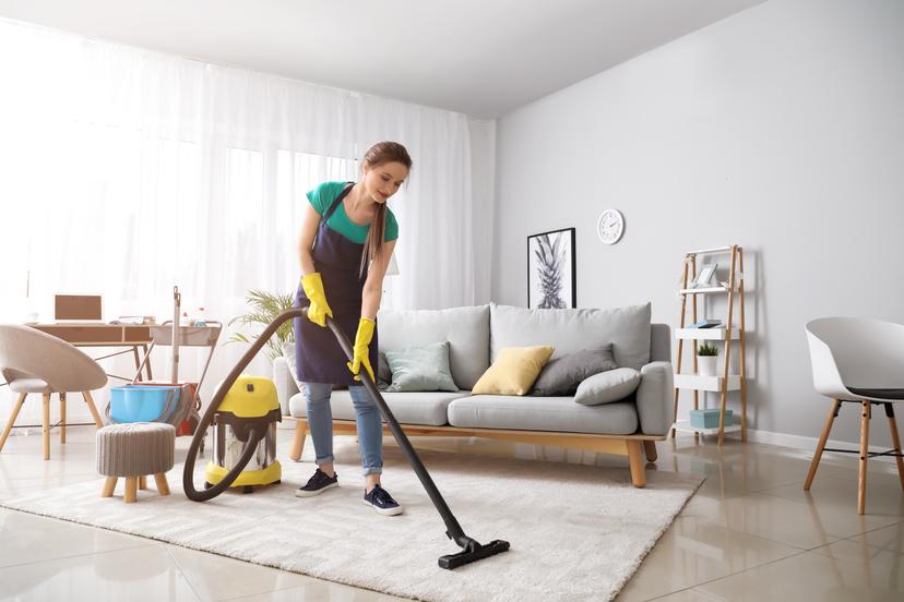 woman cleaning living room carpet